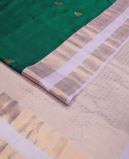 Green zari buttas Vasundhara silk mix saree, contrast rettai pettu border of thilakam, diamond, neli, muthu, and mayil designs, and jaal pallu