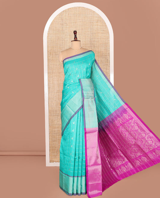 Turquoise Kuppadam Cotton Saree, Subtly Woven with Zari Butta Enclosed Checks on Its Body, Highlighted by Zari Bavanji Border, Complemented by Contrast Intricately Designed Pallu, and Paired with a Contrast Blouse
