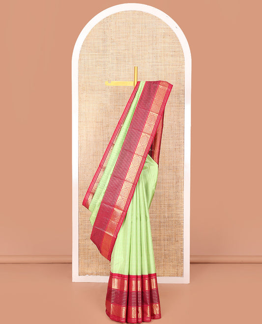 Green Vasundhara Silk Saree Subtly Sparkled with Stripes, Highlighted by a Contrast Border of Muthu, Diamond, Kamalam, and Laddu Kamalam Designs, Delicately Woven Pallu of Intricate Designs, and Paired with a Contrast Blouse