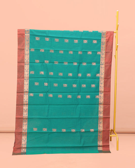Green Semi-Silk Cotton Saree, Impeccably Styled with Buttas All Over Its Body, Complemented by a Contrast Peacock Design Kal Eragina Border, Pallu Steeped with Elephant Design, and Paired with a Matching Blouse