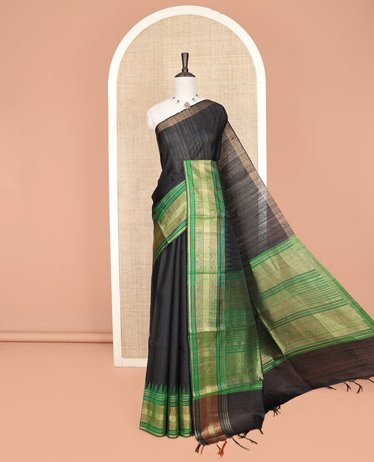 Black Plain Dupion Silk Saree, Beautifully Bedecked with a One-Sided Contrast Temple Border, Pallu Steeped with Zari Temple Designs, and Paired with a Contrast Blouse