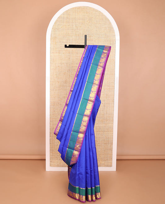 Blue striped kancheepuram silk saree with contrast border of thilakam mokku, mayil design & zari design pallu