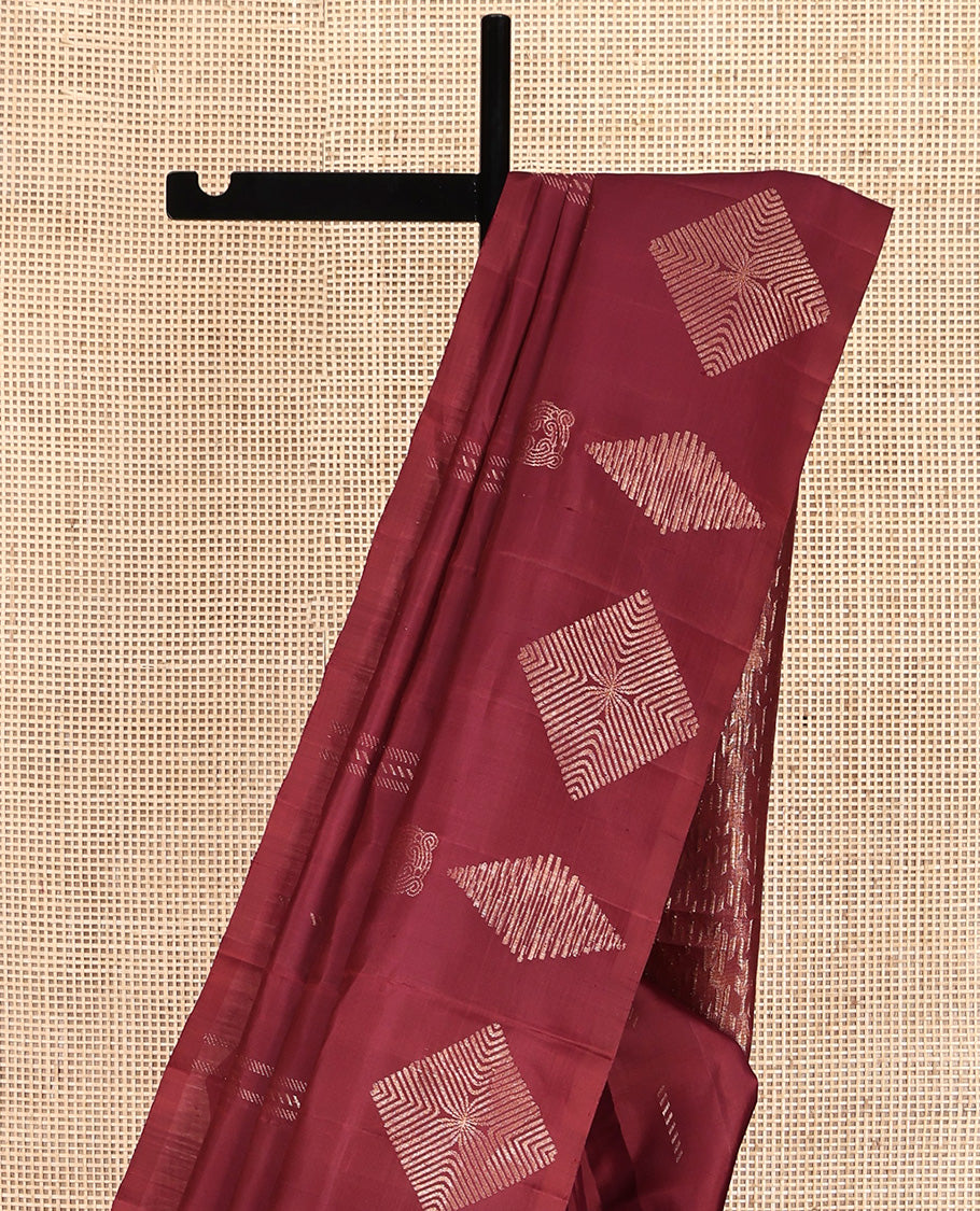 Borderless Maroon Mayuri Soft Silk Saree, Adorned with Buttas All Over Its Body, a Self-Pallu of Geometric Patterns, and Paired with a Matching Blouse