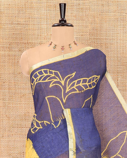 Yellow and blue batik and floral printed linen saree, contrast piping border, floral printed pallu, and a printed blouse