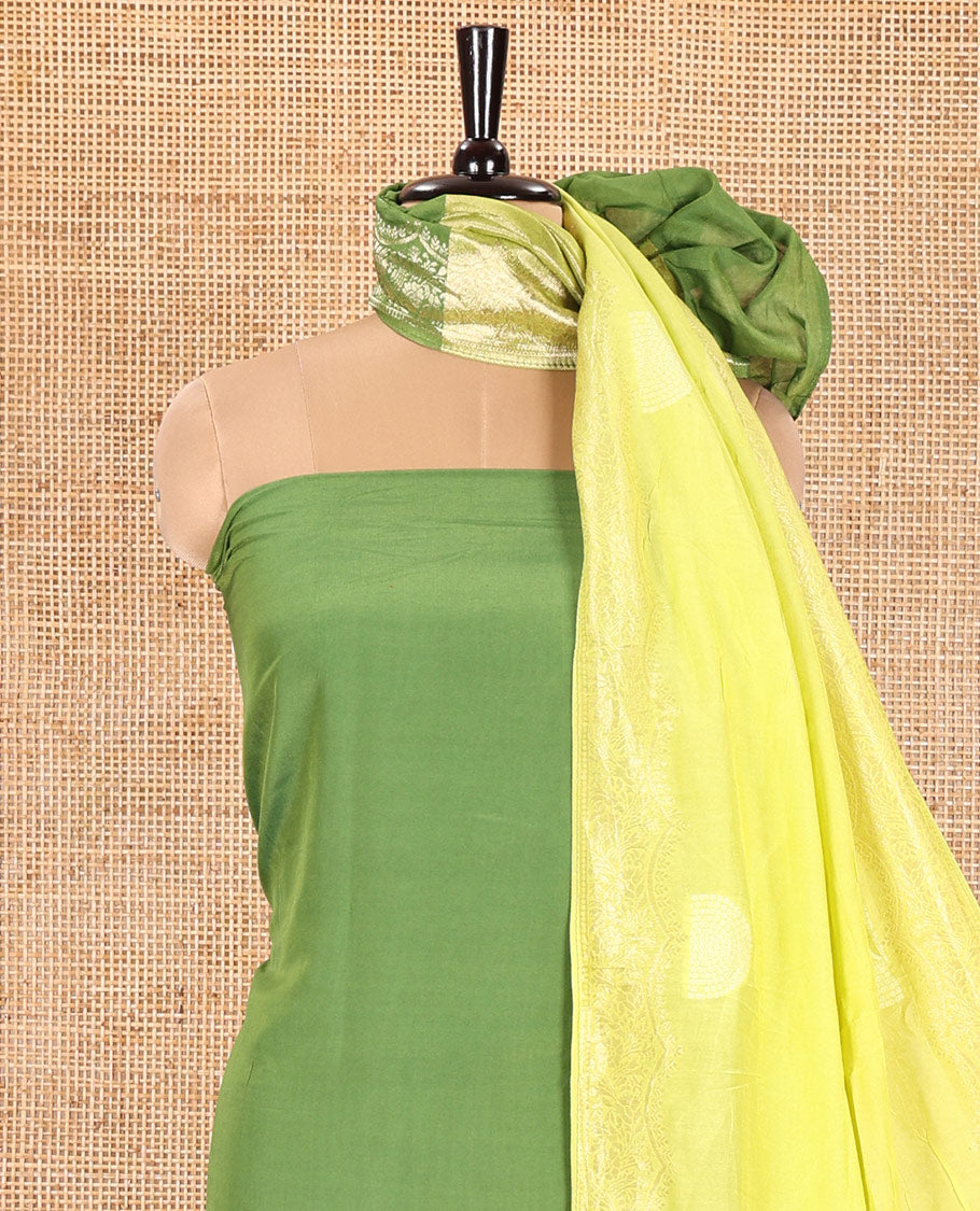 Green Semi Silk Material Churidar Set, Subtly Made Plain Top, a Plain Santoon Bottom, and Is Paired with a Dual-Colored Bandhani Motifs Semi Silk Dupatta