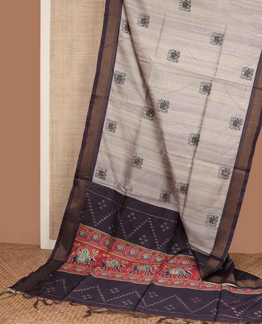 Grey zari buttas and elephant motifs tussar silk saree, contrast bavanji border, and patola style elephant motifs printed pallu
