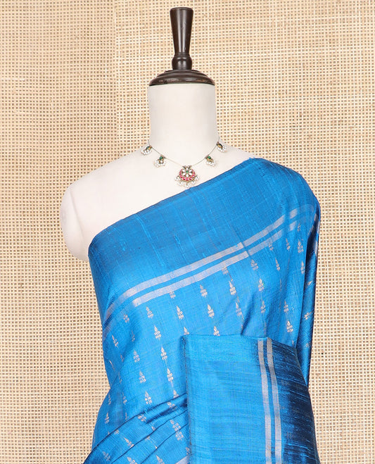 Blue Dupion Silk Saree Subtly Sparkled with Dobby-Style Buttas All Over Its Body, Subtly Woven Border, Pallu Decked Up with Floral Jaal Designs, and Paired with a Matching Blouse