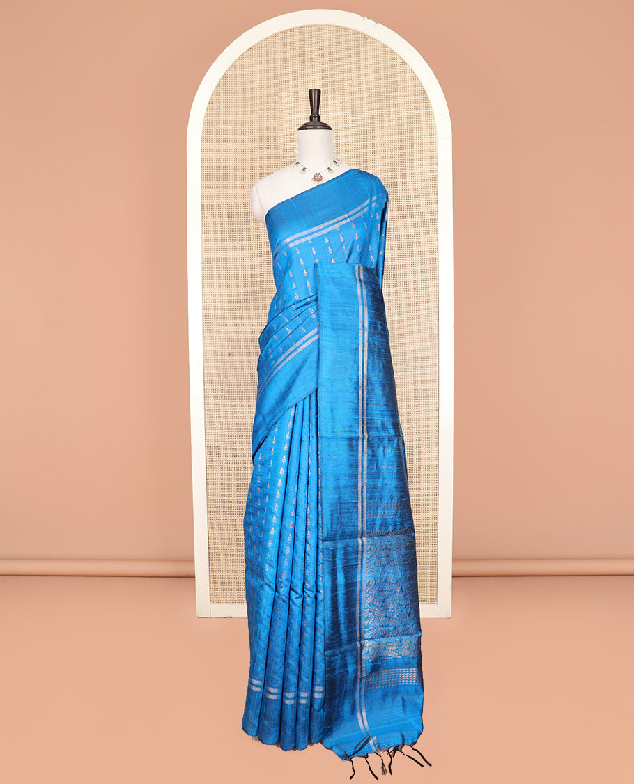 Blue Dupion Silk Saree Subtly Sparkled with Dobby-Style Buttas All Over Its Body, Subtly Woven Border, Pallu Decked Up with Floral Jaal Designs, and Paired with a Matching Blouse