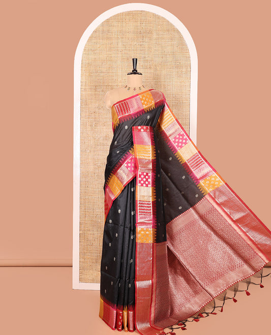 Black Semi-Raw Silk Saree, Elevated with Buttas All Over Its Body, Complemented by Contrast Meenakari-Style Woven Border of Geometric Zari Designs, Majestically Detailed Pallu, and Paired with a Contrast Blouse