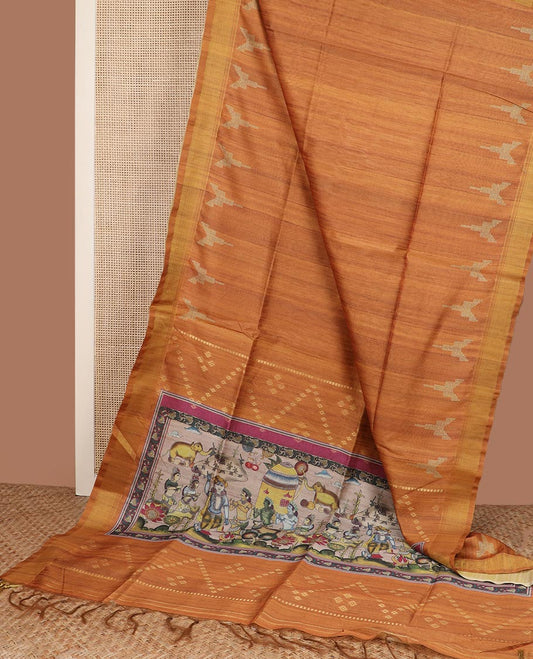 Orange plain design tussar silk saree, temple bavanji border, and figurines printed pallu