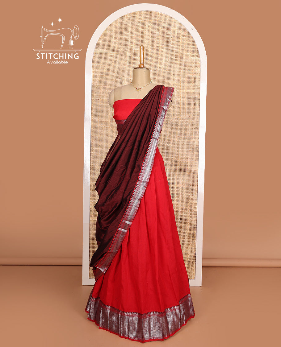 Red cotton half-saree, plain with contrast geometric bordered skirt, matching blouse, and contrast geometric bordered dhavani