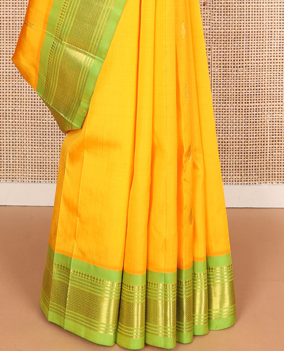 Yellow zari buttas Kanchipuram silksaree, contrast one-sided border of panner sombu,muthu & mayil kann &  zari design pallu