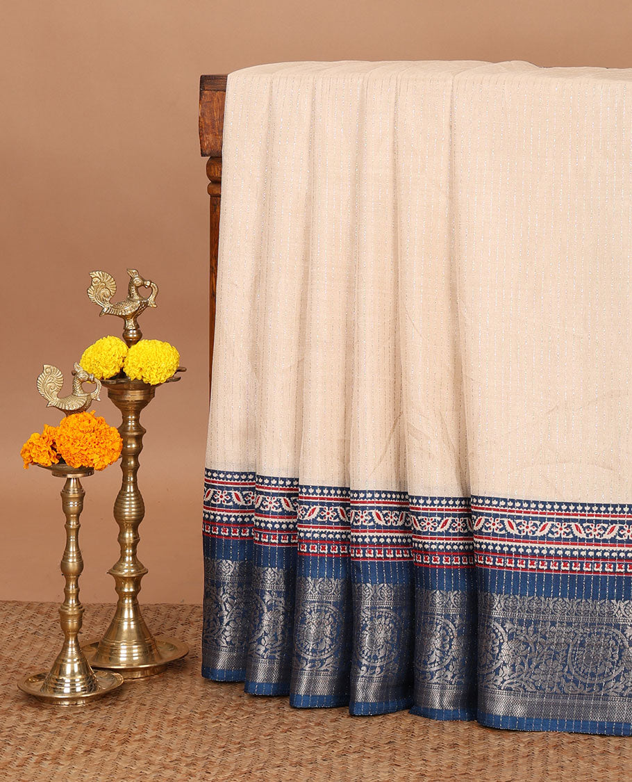Cream vertical zari striped dola silk saree, contrast blue traditional zari border & intricately Ajrakh printed pallu