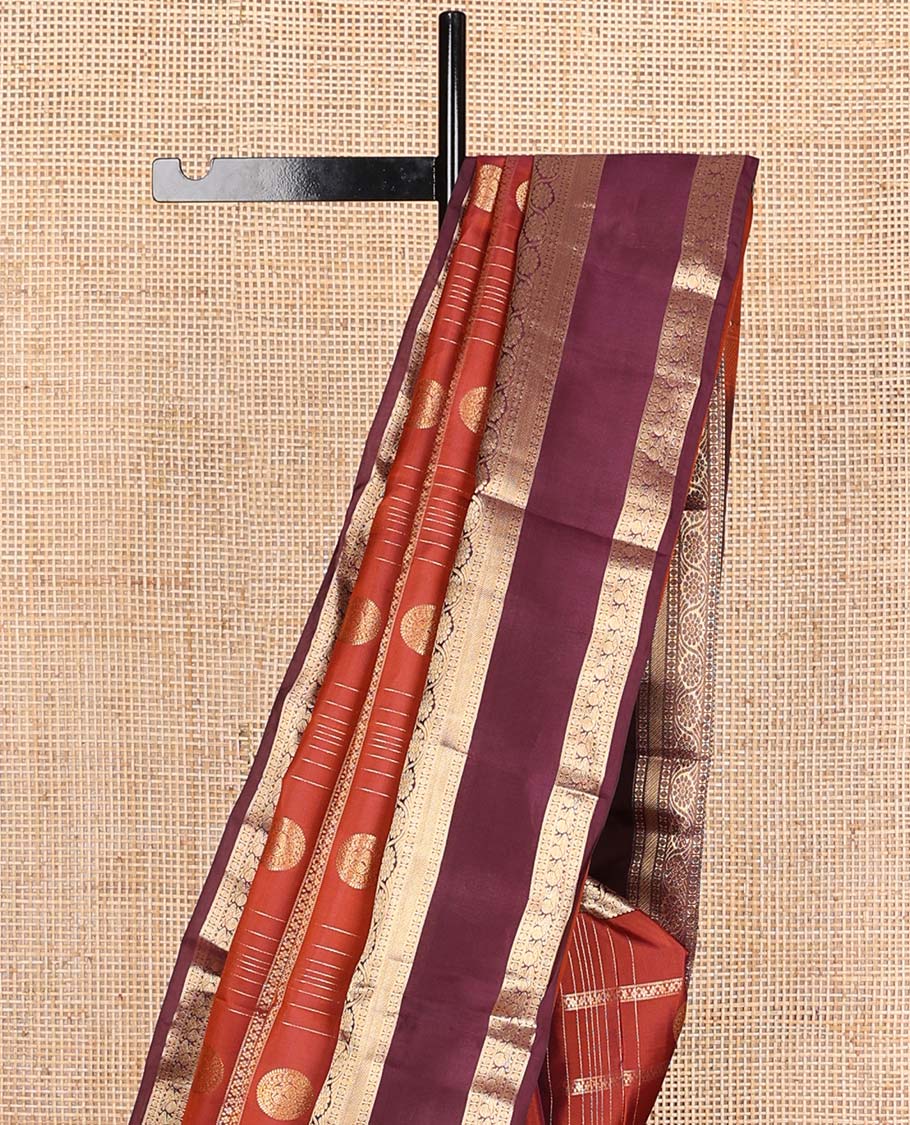 Orange zari checks and buttas Vasundhara silk mix saree, contrast rettai pettu border of rudraksham, kodi visiry and mayil designs, and scallop pallu