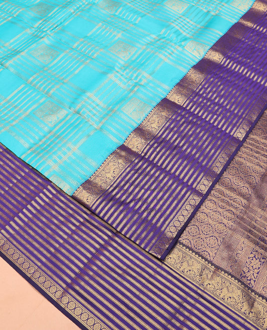 Blue zari buttas and checked Vasundhara silk mix saree, contrast varisai pettu border of salangai, yaanai, muthu, kathir, and chakram designs, and ogee patterned pallu