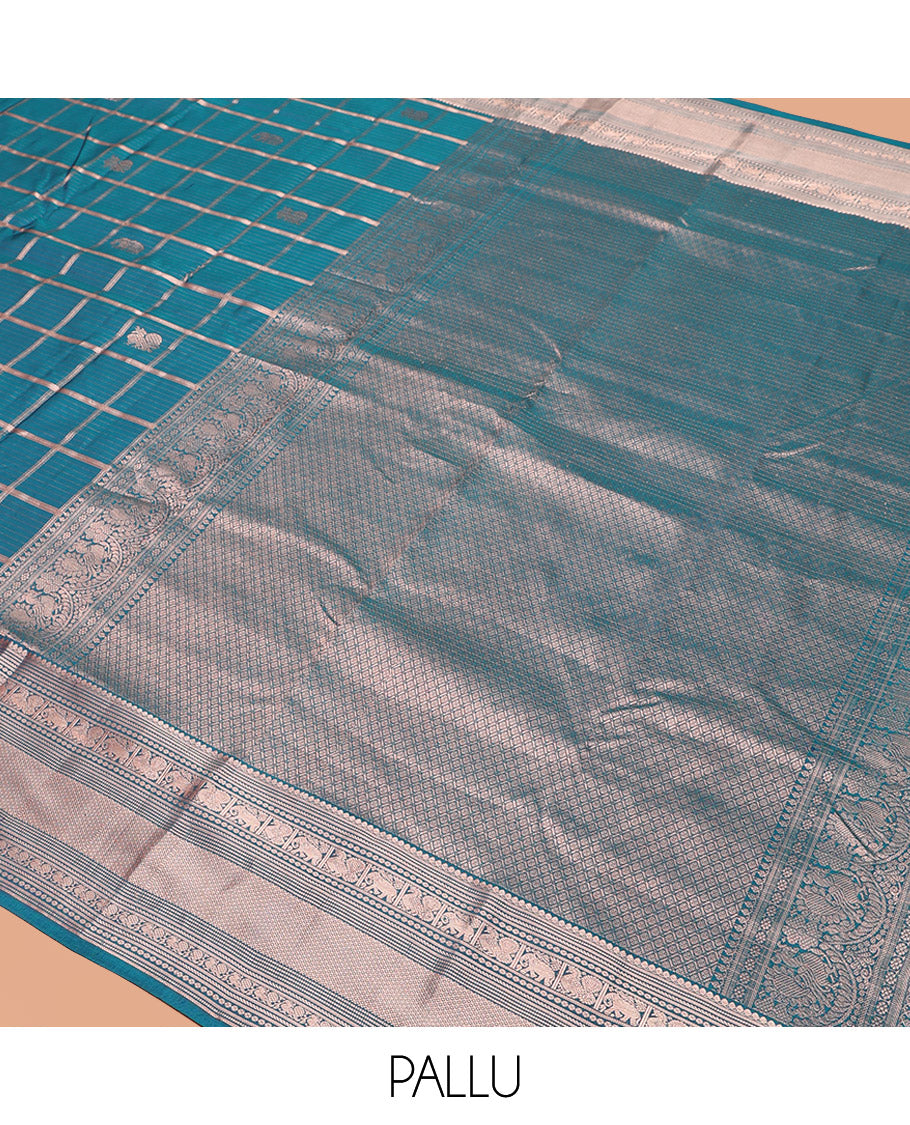 Blue Vasundhara Silk Saree Beautifully Bedecked with Medium Zari Checks, Highlighted by a Zari Border of Salngai, Mayil, Yaanai, Muthu, and Mayil Kann Designs, Delicately Woven Pallu, and Paired with a Matching Blouse