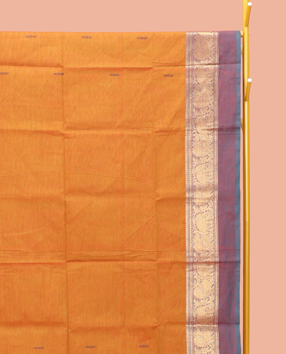 Orange Chettinad Cotton Saree, Finely Crafted with Buttas All Over Its Body, Complemented by a Contrast Ganga-Jamuna Kal Eragina Border of Kodi Peacock and Elephant Designs, Pallu of Buttas and Stripes, and Paired with a Matching Blouse