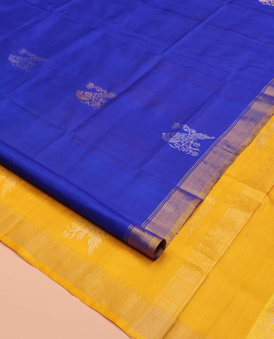 Blue Uppada Silk Saree, Showcasing Parrot Zari Buttas on Its Body, Subtle Zari Border, Complemented by a Contrast Pallu Depicting Parrot Zari Buttas, and Paired with a Contrast Blouse