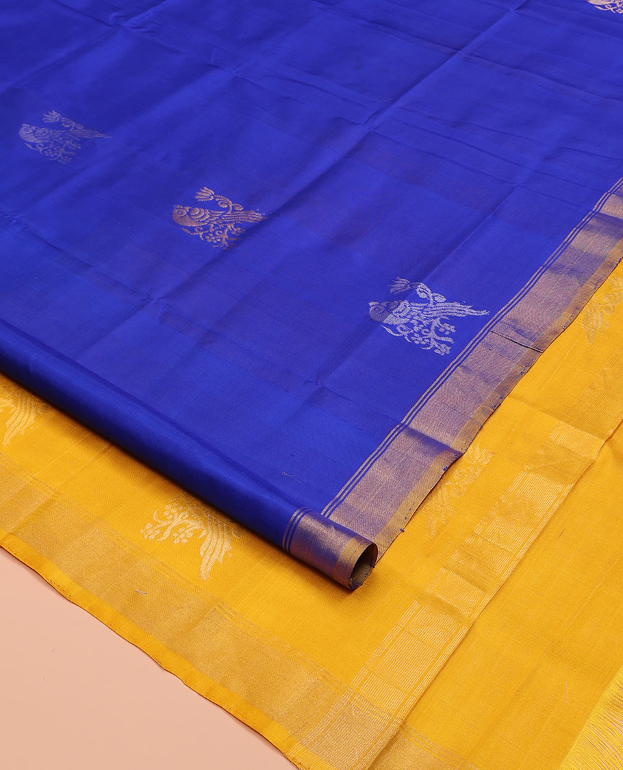 Blue Uppada Silk Saree, Showcasing Parrot Zari Buttas on Its Body, Subtle Zari Border, Complemented by a Contrast Pallu Depicting Parrot Zari Buttas, and Paired with a Contrast Blouse