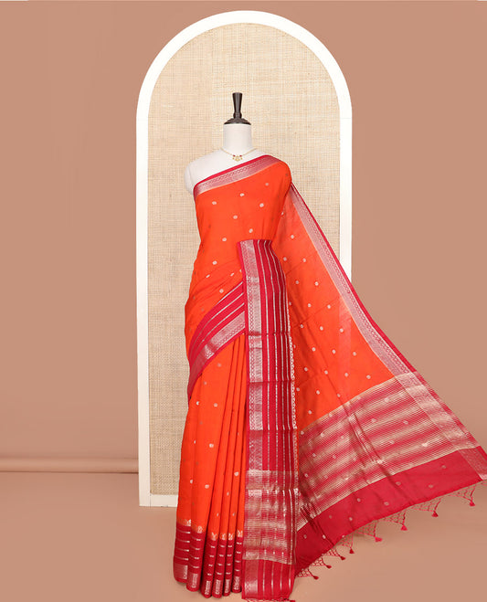 Orange Assam Silk Saree Gleamed Up with Floral Zari Buttas, Complemented by a Contrast Traditional Zari Border, a Captivating Pallu of Zari Designs, and Paired with a Contrast Blouse