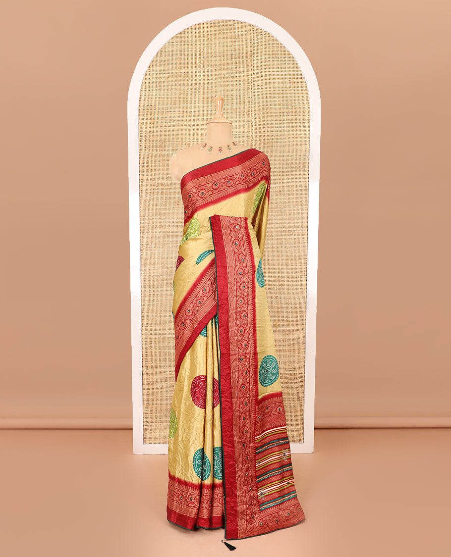Gold bandhani printed with mirror work moss crepe saree, contrast traditional design mirror work border, printed pallu of Swarovski stone work, and a contrast plain blouse