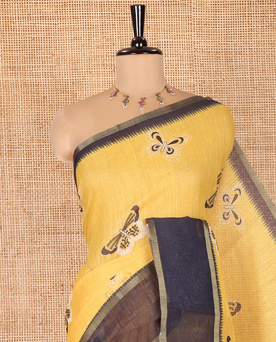 Yellow Linen Cotton Saree, Beautified with Butterfly Motifs Printed On Its Body, Complemented by Temple Border, Pallu Steeped with Butterflies, and Paired with a Contrast Blouse