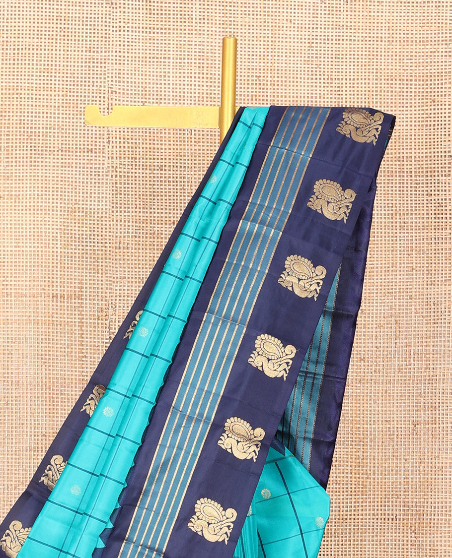 Blue Vasundhara Silk Saree, Mesmerized with Zari Butta Enclosed Checked Design on Its Body, Highlighted by a Contrast Border of Thazampoo Rekku, Banaras, and Mayil Designs, Scintillating Pallu of Jaal Design, and Paired with a Contrast Blouse