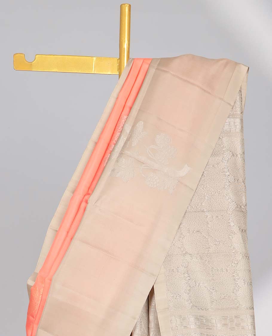 Peach floral buttas soft silk saree with contrast floral border & round buttas pallu