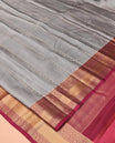 Grey Vasundhara Lite Silk Mix Saree, Subtly Sparkled With Zari Buttas All Over Its Body, Complemented by Contrast Border of Chakram and Manga Designs, Intricately Designed Pallu and Paired with a Contrast Blouse