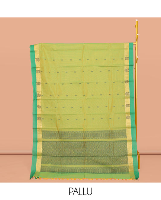 Green Kanchi Cotton Saree, Mesmerized with Buttas All Over Its Body, Complemented by a Contrast Border of Floral Designs, Pallu of Intricate Designs, and Paired with a Matching Blouse