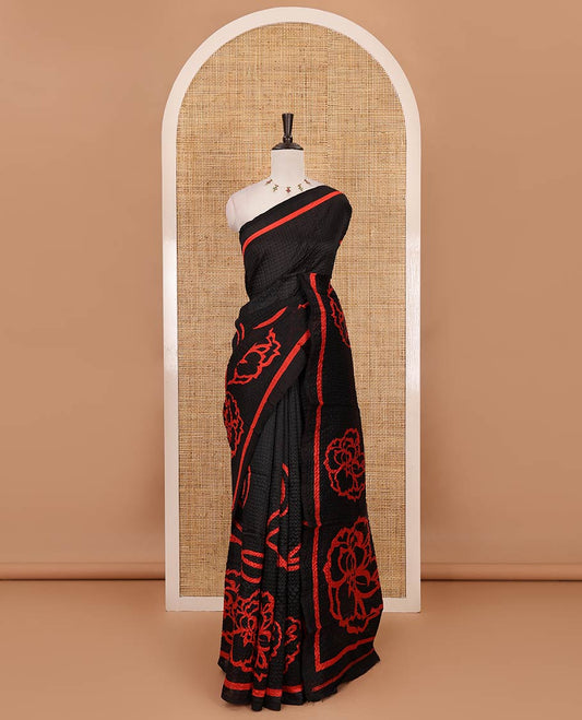 Black-base crushed litchi saree features fancy red color floral printed body, printed piping border & pallu