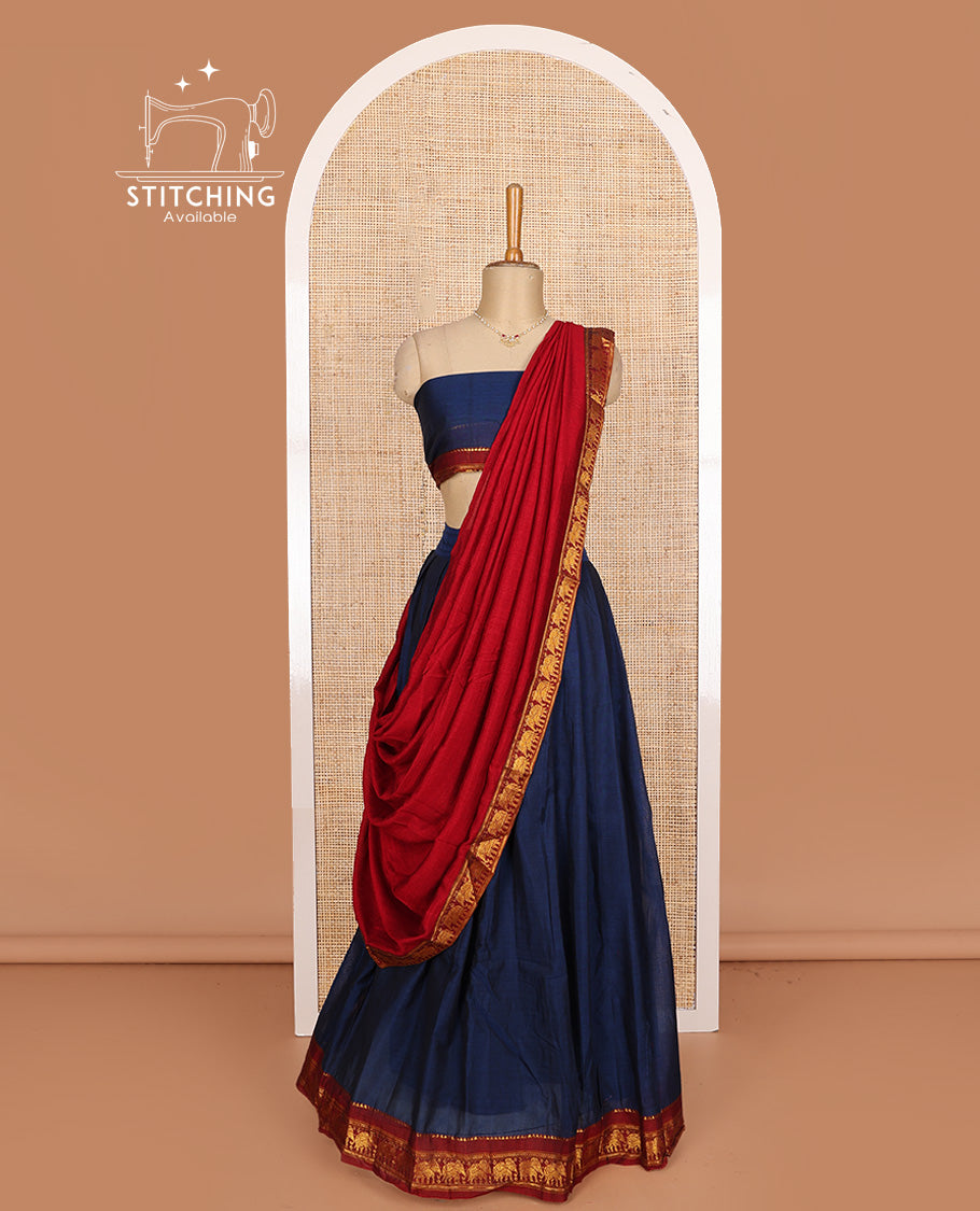 Blue cotton half-saree, plain with contrast elephant motif bordered skirt, matching blouse, and contrast elephant motif bordered dhavani