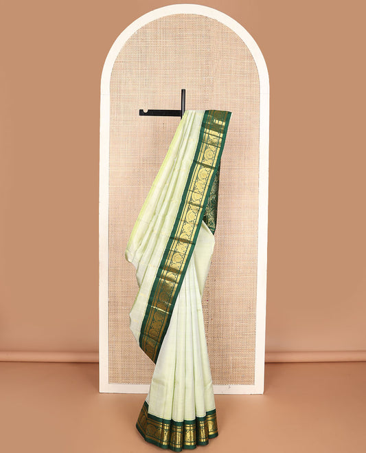 Pastel green buttas Kanchipuram silksaree, contrast one-sided korvai zari design border & annam chakram checked pallu