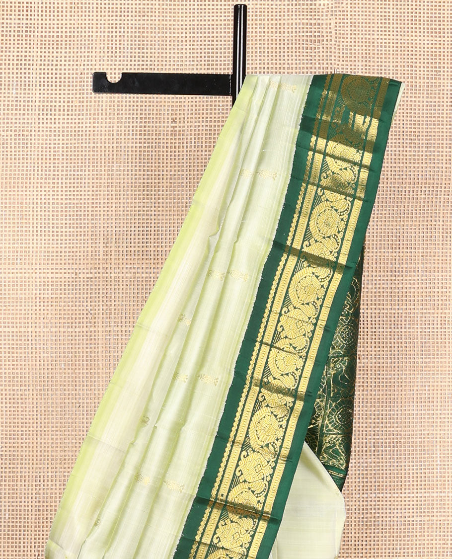 Pastel green buttas Kanchipuram silksaree, contrast one-sided korvai zari design border & annam chakram checked pallu
