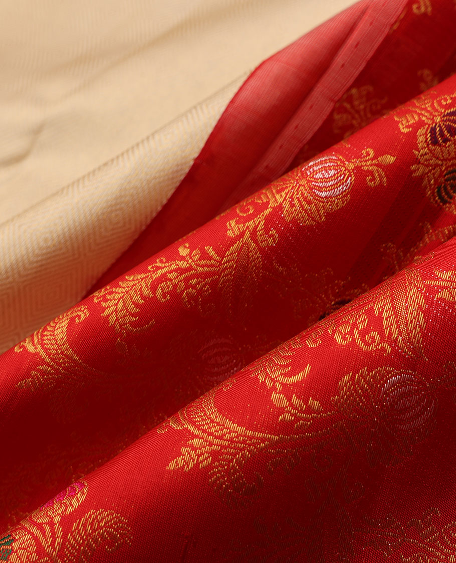 Cream embossed silk saree, contrast red border & pallu features meenakari resham thread woven floral jaal design