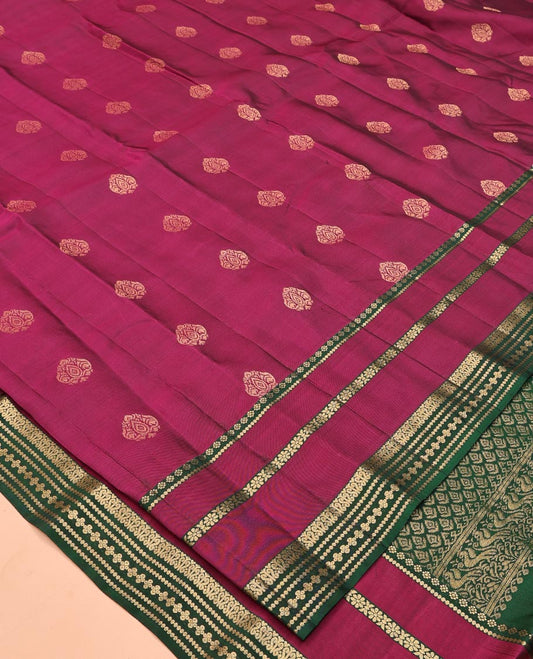 Maroon Vasundhara Lite Silk Mix Saree, Decked Up with Zari Buttas All Over Its Body, Complemented by Contrast Varisai Pettu Zari Border, Grandly Decked Up Pallu, and Paired with a Contrast Blouse