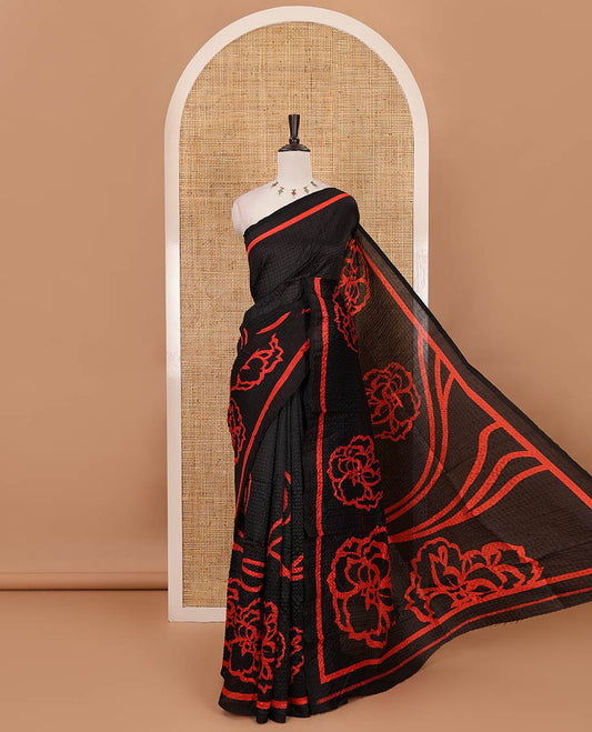 Black-base crushed litchi saree features fancy red color floral printed body, printed piping border & pallu
