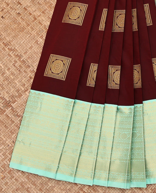 Maroon Budget Silk Saree, Mesmerized with Square-Shaped Zari Buttas All Over Its Body, Complemented by a Contrast Traditional Zari Design Border, Gleaming Jaal Pallu, and Paired with a Contrast Blouse