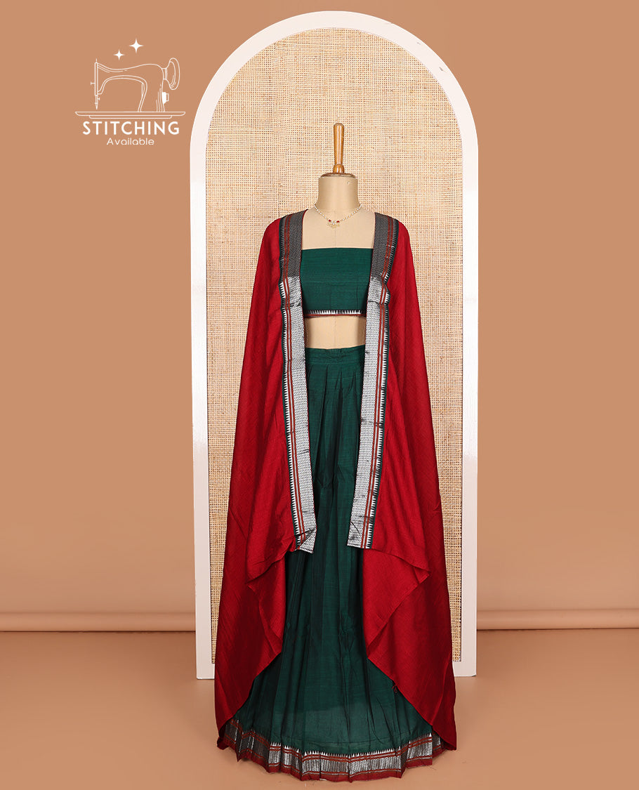Dark green cotton half-saree, plain with contrast geometric bordered skirt, matching blouse, and contrast geometric bordered dhavani