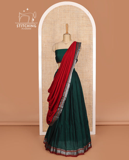 Dark green cotton half-saree, plain with contrast geometric bordered skirt, matching blouse, and contrast geometric bordered dhavani