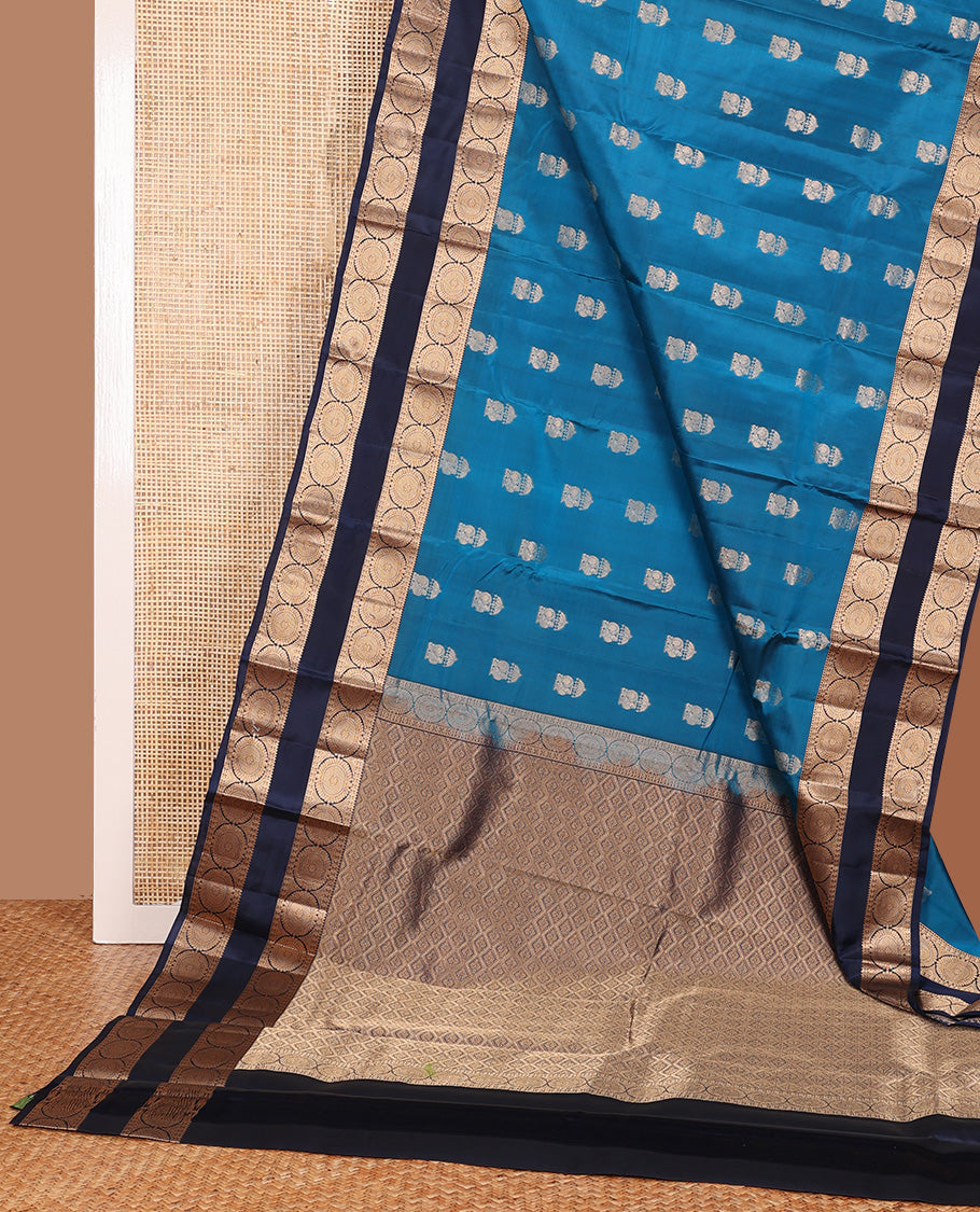 Blue zari buttas Vasundhara silk mix saree, contrast rettai pettu border of rekku, poun, and chakram motifs, and jaal pallu