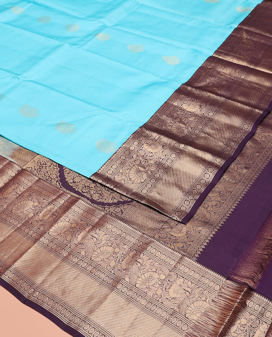Blue Vasundhara Silk Saree, Richly Detailed with Stripes and Zari Buttas, Complemented by a Contrast Border of Thilakam Mokku, Laddu Kamalam, and Kodi Visiry and Mayil Designs, Mughal-Style Designed Pallu, and Paired with a Contrast Blouse