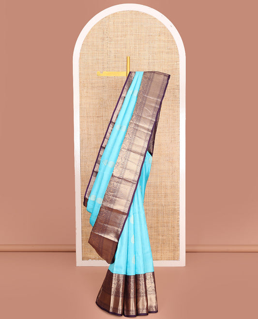 Blue Vasundhara Silk Saree, Richly Detailed with Stripes and Zari Buttas, Complemented by a Contrast Border of Thilakam Mokku, Laddu Kamalam, and Kodi Visiry and Mayil Designs, Mughal-Style Designed Pallu, and Paired with a Contrast Blouse