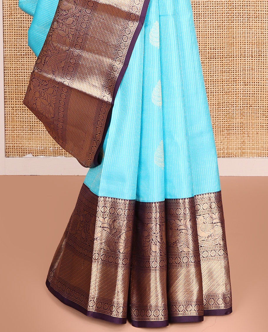 Blue Vasundhara Silk Saree, Richly Detailed with Stripes and Zari Buttas, Complemented by a Contrast Border of Thilakam Mokku, Laddu Kamalam, and Kodi Visiry and Mayil Designs, Mughal-Style Designed Pallu, and Paired with a Contrast Blouse
