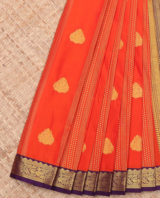 Orange Budget Silk Saree, Depicting Zari Buttas All Over Its Body, Complemented by a Contrast Traditional Zari Design Border of Peacocks, a Pallu Steeped with Traditional Design, and Paired with a Contrast Blouse