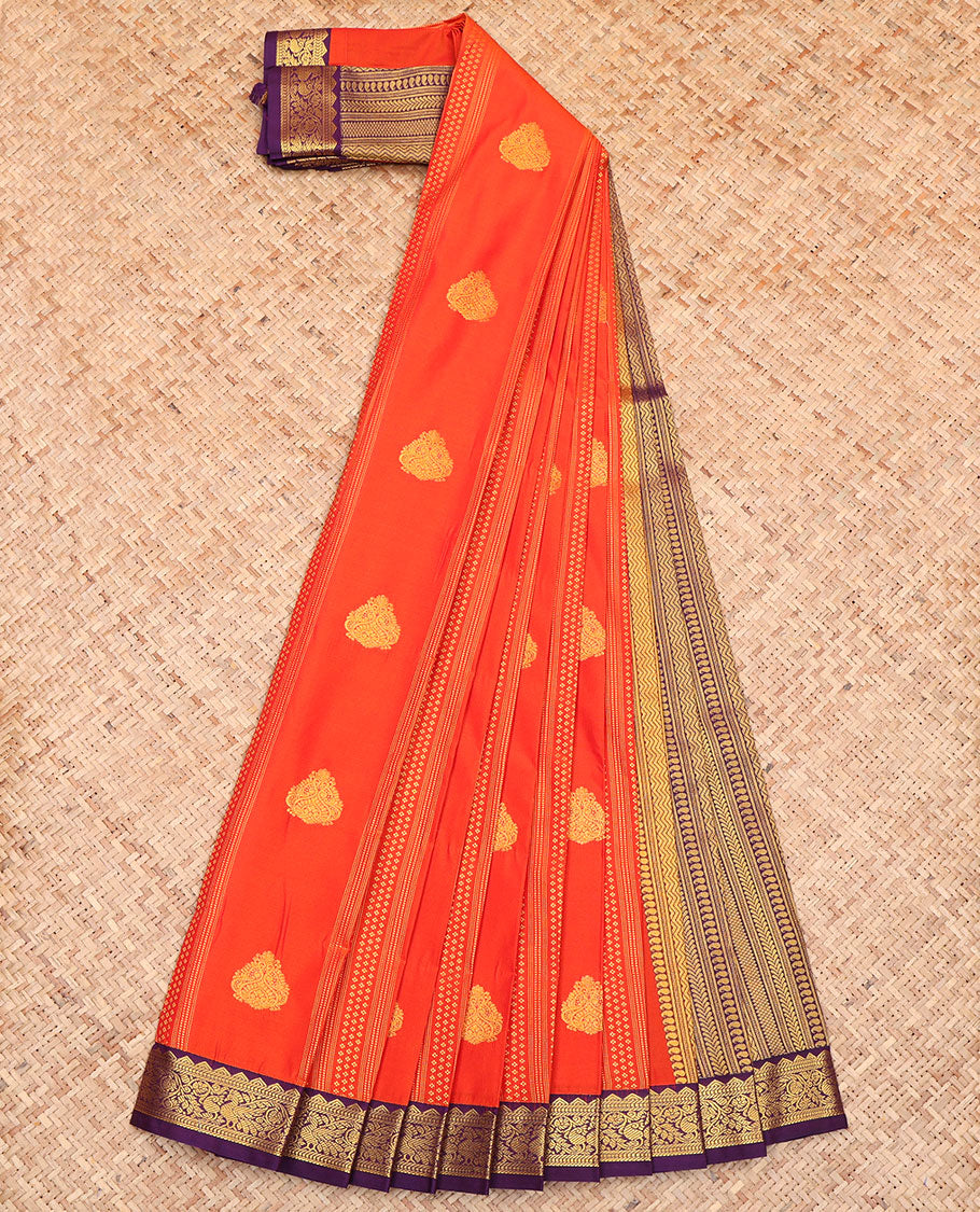 Orange Budget Silk Saree, Depicting Zari Buttas All Over Its Body, Complemented by a Contrast Traditional Zari Design Border of Peacocks, a Pallu Steeped with Traditional Design, and Paired with a Contrast Blouse