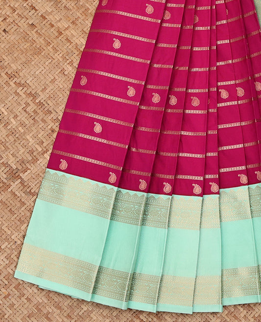 Dark Pink Budget Silk Saree, Enthralled with Zari Stripes and Paisley Buttas All Over Its Body, Complemented by a Contrast Temple Traditional Zari Design Rettai Pettu Border, Sparsely Woven Pallu, and Paired with a Contrast Blouse