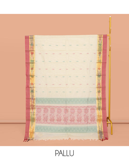 Off-White Kanchi Cotton Saree, Showcasing Buttas All Over Its Body, Complemented by a Contrast Ikkat Border, Pallu of Floral Designs, and Paired with a Matching Blouse