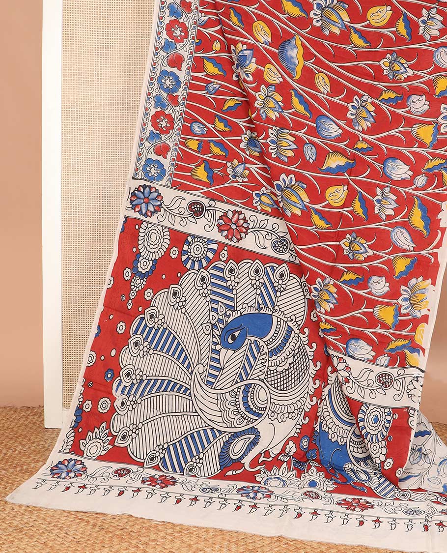 Red lotus floral motifs machine printed kalamkari cotton saree, floral creeper printed border, and peacock printed pallu