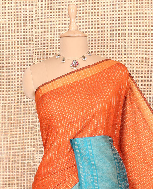 Rust orange zari dot enclosed checked semi-raw silk saree, contrast traditional zari design border, contrast diamond patterned pallu, and a contrast blouse